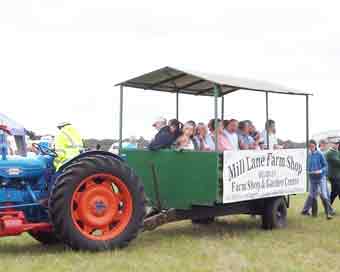 Rides on large trailer pulled by tractor